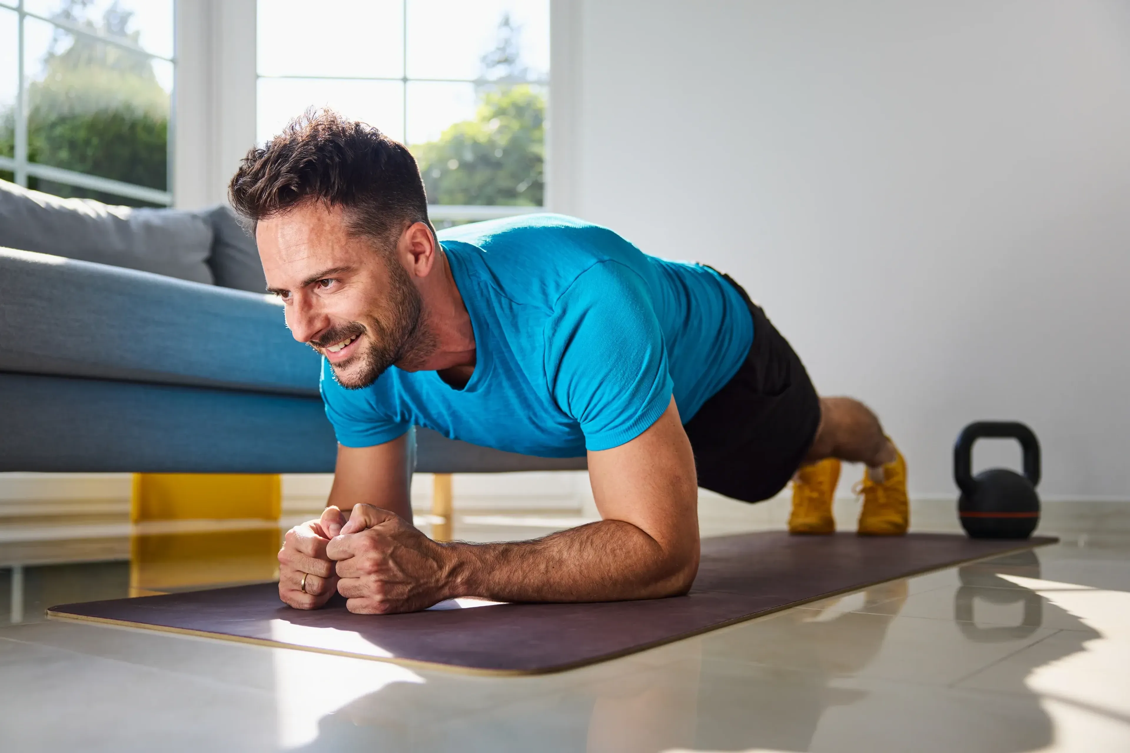 Smiling man doing plank