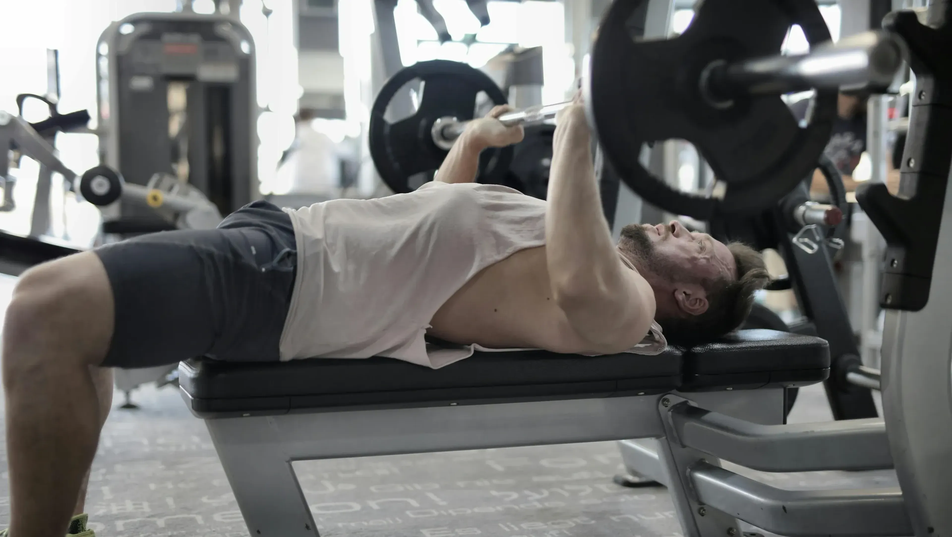 A man doing barbell bench press