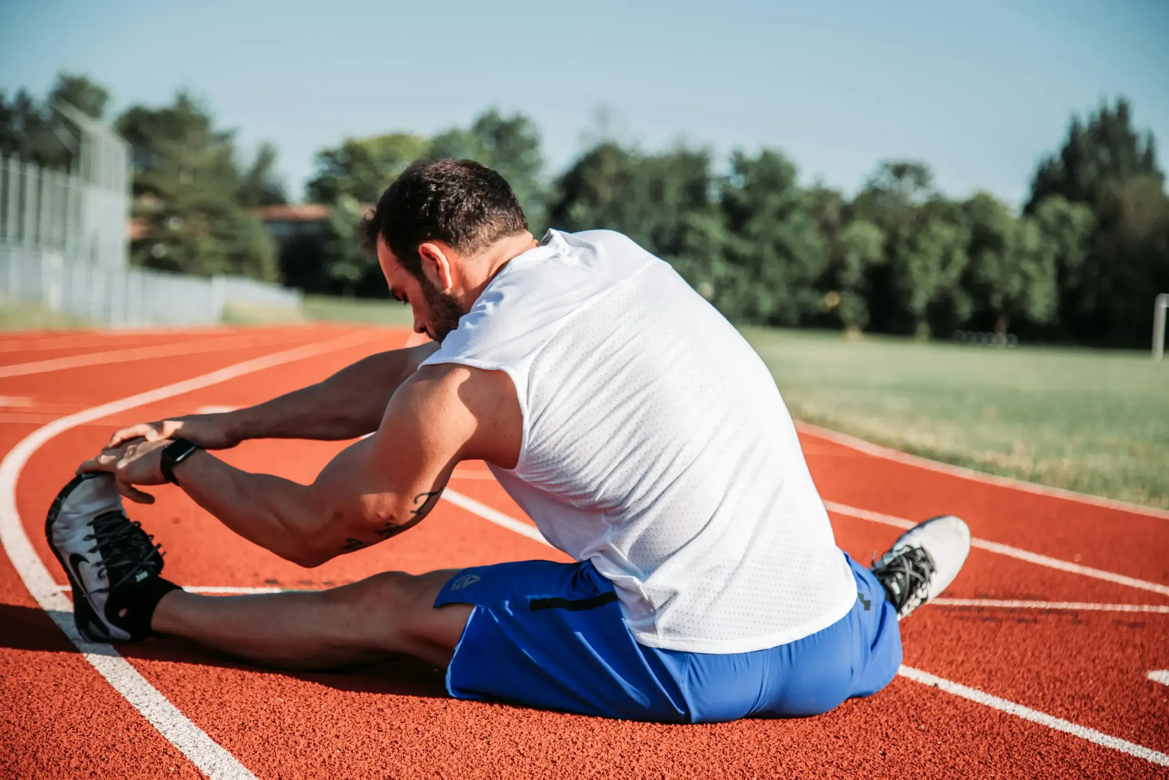 Person stretching in a running field