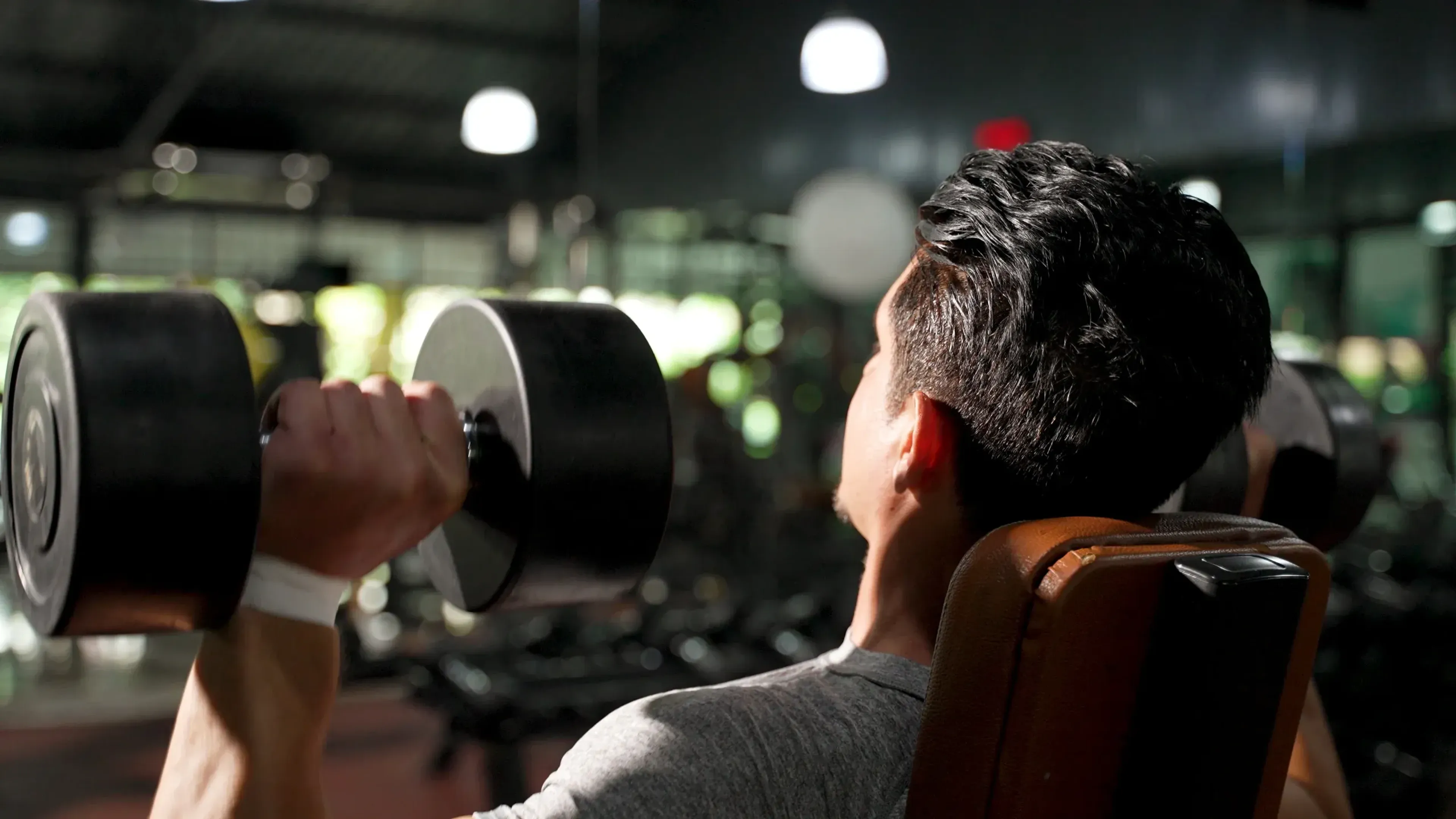 Athlete performing seated dumbbell shoulder press