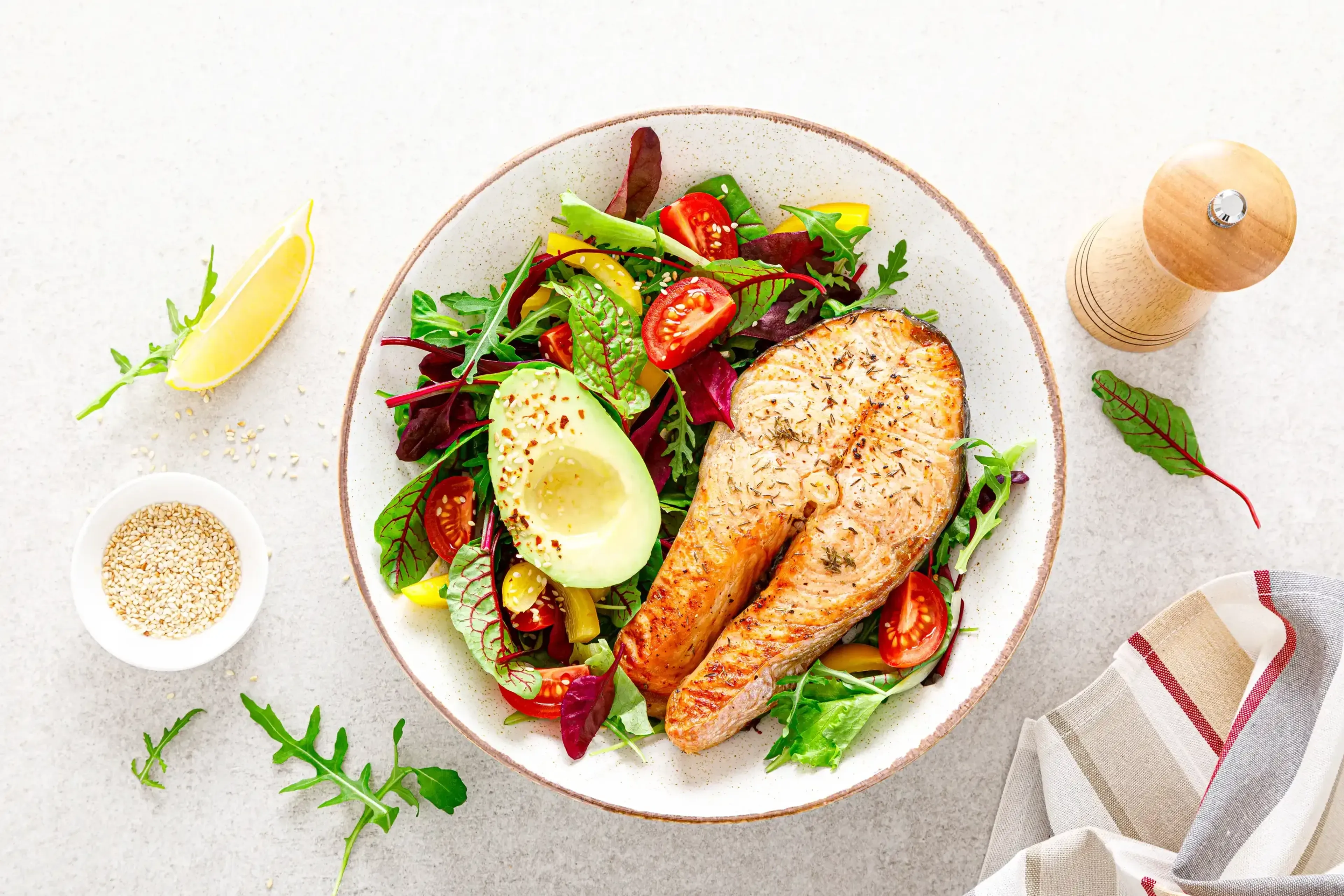Salmon grilled steak with avocado and fresh vegetables
